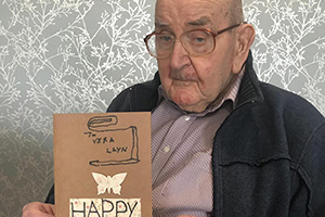 A man from Aaron Court Care Home holding a card he had made