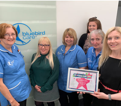 Bluebird Care staff with award