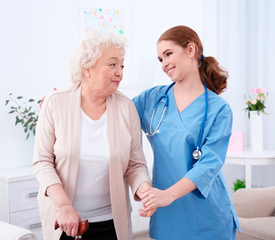 A resident & care home nurse in a bright lighting in a care environment
