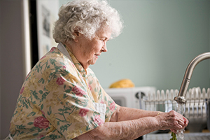 Missed dementia cases - lady stood at the sink